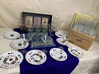 full lot overview showing plates, glasses, pitcher, boxed pint glasses