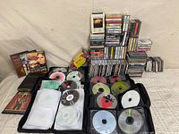 Overall view of cassette stacks, CD jewel cases, two open CD wallets