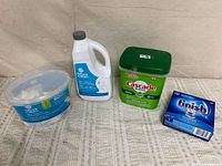 All four cleaning products lined up left-to-right