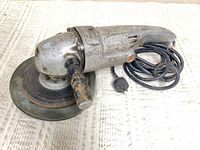 Full view of grinder-polisher showing body, disc and cord