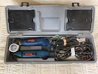 Open grey case showing two Ryobi rotary tools, cords and accessories