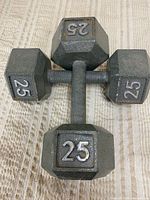 Top view of two grey hex dumbbells showing 25 lb markings