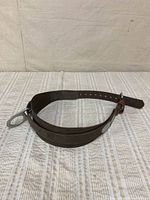 Full view of brown lineman safety belt laid flat