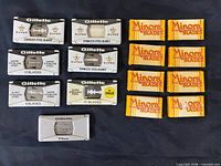 Overview of nine Gillette dispensers and nine Minora packs on black background