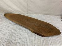 Full view of walnut slab on fabric backdrop