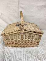 Closed wicker picnic basket showing weave and handle