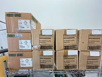 Eight master cartons on metal shelf: four Corporate Express paper clips, four Alliance Rubber bands