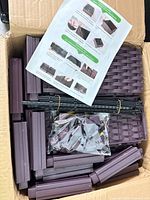 Box of unassembled planter components, instruction sheet visible