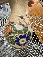 Front view showing bird and floral decoration on vase