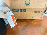 Outer brown Uline shipping carton marked Rubber Bands with one inner box shown