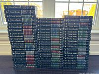 Front spines of all 60 volumes stacked in rows