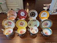 All eight teacup and saucer sets displayed together