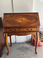 Full view of wooden secretary desk showing overall design and legs