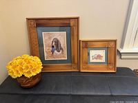 Larger and smaller framed dog prints with faux flower planter