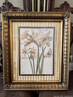 Full view of framed botanical wall art on chair