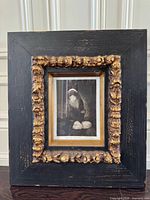 Full view of framed etching with ornate frame