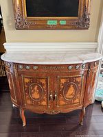 Full front view showing marble top, ormolu mounts and marquetry