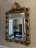 Full front view showing complete mirror and ornate crest