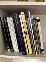 Group of 18 books on shelf showing spines and quantity