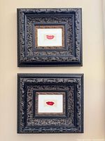 Both framed lip art prints hung vertically