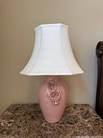 Front view of pink ceramic lamp with white shade