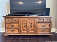 Front view of Thomasville solid wood console table with six drawers and central doors