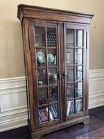 Full frontal view of wooden glass-door display cabinet