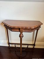 Full view of wooden half-moon side table