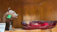 Bear figurine and cranberry bowl on shelf