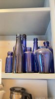 shelf view showing group of cobalt blue glass containers