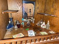 Shelf containing all perfume bottles and compacts