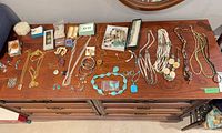 Dresser top view showing all necklaces, bracelets, earrings, pendants, watch