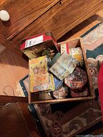 Drawer holding multiple decorative tins of varying designs and shapes