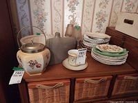 Group view of biscuit jar, planter, vase, teacup, stacked plates and divided dish