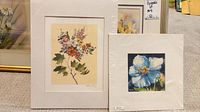 Two framed floral prints: Heather Collis bouquet print (left) and Sonia Day blue flower print (right)