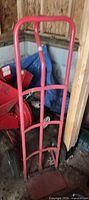 Full view of red steel hand truck showing frame and height