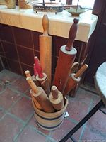 Crock containing rolling pins, room setting