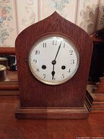 Front view showing entire mahogany mantel clock and dial