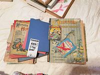 Stack of vintage children’s books including Picture Word Book, Mother Hubbard, small airplane and Donald Duck titles