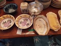 Assorted dishes, platters, bowls, metal footed bowl and canister on table