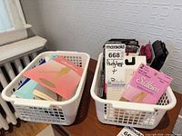Two baskets filled with packaged hosiery