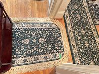 Small accent rug next to runner showing pattern and fringe