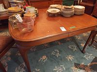 Full view of dining table top, cabriole legs visible