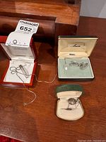 All three jewellery pieces in their cases