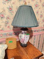 Table lamp and vase on wooden table