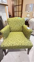 Front view of green damask armchair showing full shape and legs