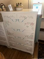 Front view showing dresser, floral stenciling and knob layout