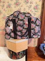 floral duffel on two hat boxes