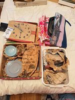 Overall lot showing clock radio, pouches, cups packaged in trays