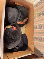 Multiple hats inside cardboard box